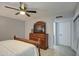 Bedroom with large dresser, ceiling fan, and ensuite bathroom access at 8152 W Sierra Vista Dr, Glendale, AZ 85303