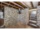 Finished basement with unique stone wall and ceiling fan at 901 W Culver St, Phoenix, AZ 85007