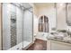 Updated bathroom with a walk-in shower, granite vanity, and arched window at 901 W Culver St, Phoenix, AZ 85007