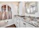 Bathroom with double sinks, granite countertops, and an elegant mirror at 901 W Culver St, Phoenix, AZ 85007