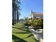 Home exterior showcasing a side yard with palm trees and lush landscaping at 901 W Culver St, Phoenix, AZ 85007