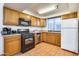 Galley kitchen with wood cabinets, stainless steel appliances, and tile floor at 901 W Culver St, Phoenix, AZ 85007