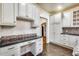 Bright kitchen with white cabinets, hexagon tile backsplash, and built-in desk at 901 W Culver St, Phoenix, AZ 85007