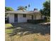View of the backyard with a grapefruit tree and lawn area at 10103 W Forrester Dr, Sun City, AZ 85351