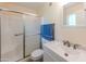 Updated bathroom with white vanity, shower, and tile flooring at 10103 W Forrester Dr, Sun City, AZ 85351