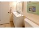 Bathroom with white vanity, toilet and large mirror at 10103 W Forrester Dr, Sun City, AZ 85351