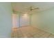 Light green bedroom with ceiling fan and tile floors at 10103 W Forrester Dr, Sun City, AZ 85351