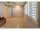 Bright bedroom with tile floors, ceiling fan, and window shutters at 10103 W Forrester Dr, Sun City, AZ 85351