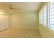 Light green bedroom with ceiling fan and tile floors at 10103 W Forrester Dr, Sun City, AZ 85351