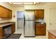 Kitchen with stainless steel refrigerator and laundry at 10103 W Forrester Dr, Sun City, AZ 85351