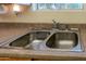 Double stainless steel sink with chrome faucet in kitchen at 10103 W Forrester Dr, Sun City, AZ 85351