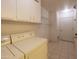 Laundry room with washer, dryer, cabinets, and extra shelving at 10103 W Forrester Dr, Sun City, AZ 85351