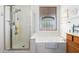 Clean bathroom with a walk-in shower and a relaxing bathtub at 17218 N 54Th Ln, Glendale, AZ 85308