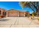 Tan house with two-car garage and desert landscaping at 17218 N 54Th Ln, Glendale, AZ 85308