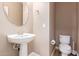 Small bathroom with pedestal sink and toilet at 1864 W Buckhorn Trl, Phoenix, AZ 85085