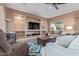 Spacious living room with built-in shelving and a large TV at 1864 W Buckhorn Trl, Phoenix, AZ 85085