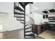 Modern kitchen with dark cabinetry, spiral staircase, and island at 18811 N 19Th Ave # 3025, Phoenix, AZ 85027