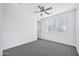 Bright bedroom with dual windows, ceiling fan, and access to a closet at 20385 W Terrace Ln, Buckeye, AZ 85396