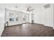 Bright living room with wood-look tile floors and windows overlooking backyard at 20385 W Terrace Ln, Buckeye, AZ 85396