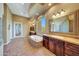 Bathroom with soaking tub, double vanity, and glass block shower at 24686 N 120Th Pl, Scottsdale, AZ 85255