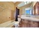 Bathroom with shower/tub combo, toilet and a vanity with dark wood cabinets at 24686 N 120Th Pl, Scottsdale, AZ 85255