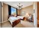 Well-lit bedroom with two twin beds, a rocking chair, and large window at 24686 N 120Th Pl, Scottsdale, AZ 85255