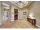 Hallway with built-in bookcase and tiled floors at 24686 N 120Th Pl, Scottsdale, AZ 85255