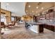 Gourmet kitchen boasts a large island, granite countertops, and dark wood cabinets at 24686 N 120Th Pl, Scottsdale, AZ 85255
