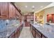 Kitchen features dark wood cabinets, granite countertops, and stainless steel appliances at 24686 N 120Th Pl, Scottsdale, AZ 85255