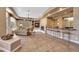 Open living space with a fireplace, bar, and plenty of natural light at 24686 N 120Th Pl, Scottsdale, AZ 85255