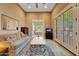 Sitting room with a sofa, coffee table, and French doors leading outside at 24686 N 120Th Pl, Scottsdale, AZ 85255