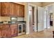 Wet bar with dark wood cabinets, granite countertop and wine cooler at 24686 N 120Th Pl, Scottsdale, AZ 85255