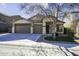 Light-colored house with a two-car garage and landscaping at 44469 W Canyon Creek Dr, Maricopa, AZ 85139