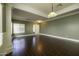 Spacious living room with hardwood floors and neutral walls at 44469 W Canyon Creek Dr, Maricopa, AZ 85139