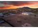 Aerial view of a modern home with circular landscaping and mountain backdrop at 475 W Saddle Mountain Road --, Phoenix, AZ 85086