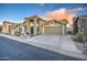 Tan two-story house with desert landscaping and a two-car garage at 5285 S Marble Dr, Gold Canyon, AZ 85118