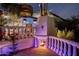 Outdoor fireplace with stone patio and elegant balustrade at night at 5317 N 46Th St, Phoenix, AZ 85018