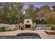 Outdoor fireplace with seating area and pool view at 5317 N 46Th St, Phoenix, AZ 85018