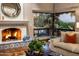Cozy living room with a fireplace and large windows overlooking scenic views at 5317 N 46Th St, Phoenix, AZ 85018