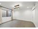 Bright bedroom with neutral walls, tile floors and a modern chandelier at 5421 E Cannon Dr, Paradise Valley, AZ 85253