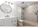 Updated bathroom with walk-in shower and white vanity at 6306 W Mitchell Dr, Phoenix, AZ 85033