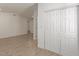 Spacious bedroom with tile floors and double door closet at 6306 W Mitchell Dr, Phoenix, AZ 85033