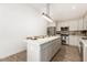 Modern kitchen with white cabinets and large island at 6306 W Mitchell Dr, Phoenix, AZ 85033