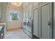 Bright laundry room with built-in cabinets and high-end washer and dryer at 6322 E Turquoise Ave, Paradise Valley, AZ 85253