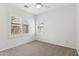 Well-lit bedroom featuring carpet, ceiling fan and window shutters at 7746 E Auburn St, Mesa, AZ 85207