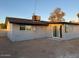 Rear view of gray house exterior with sliding glass door at 8249 W Earll Dr, Phoenix, AZ 85033