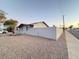 Side view of gray house exterior with a gray fence at 8249 W Earll Dr, Phoenix, AZ 85033