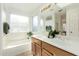 Bathroom with double vanity, soaking tub, and shower at 915 W Spur Ave, Gilbert, AZ 85233