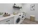 Bright laundry room with washer, dryer, and ample storage at 935 N 97Th Way, Mesa, AZ 85207