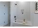 Clean bathroom with white subway tile, a bathtub, and a shower at 943 N 97Th Way, Mesa, AZ 85207